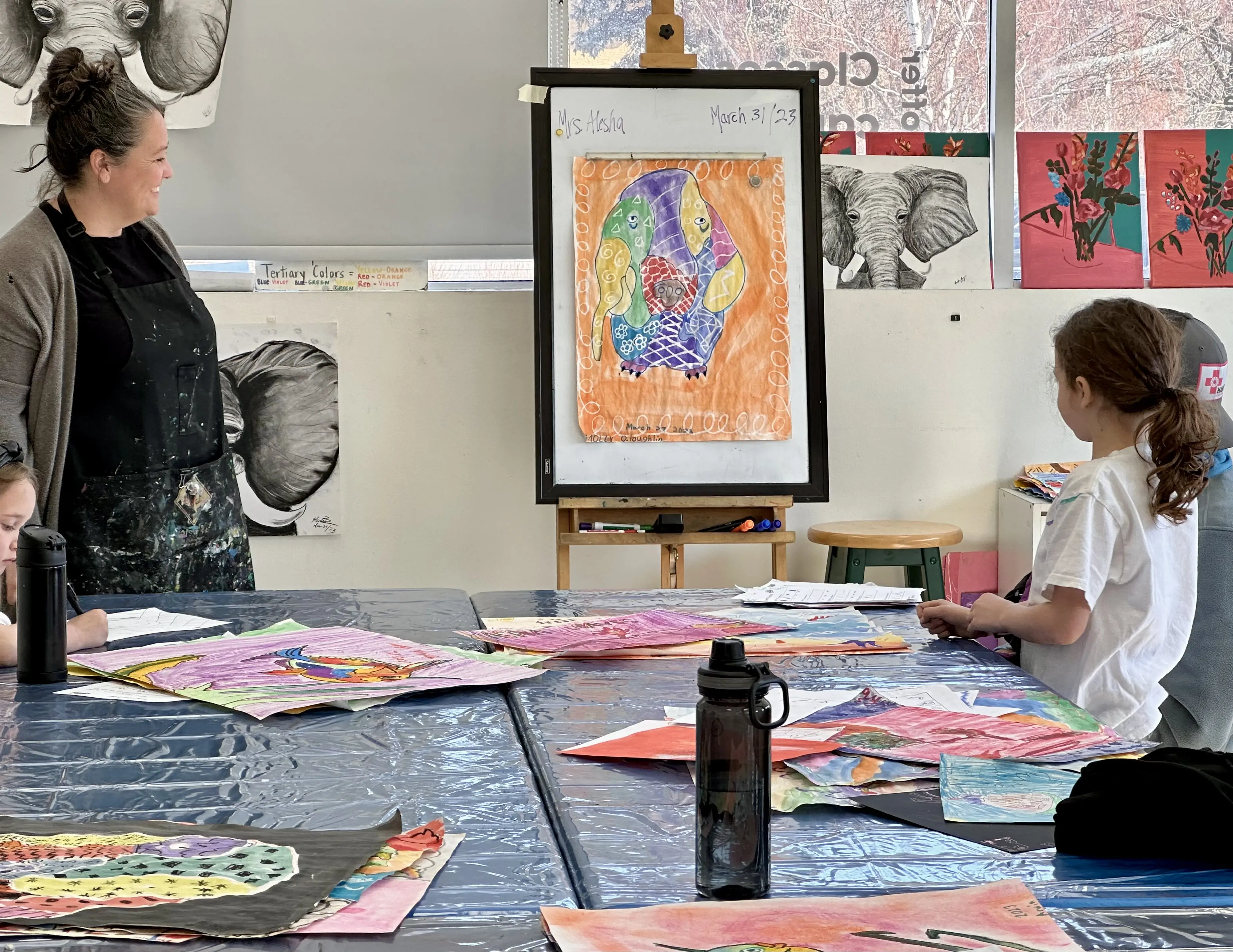 Art instructor Alesha Buczny Brown teaching a young student during a drawing and coloring class at Aliki’s Art House.