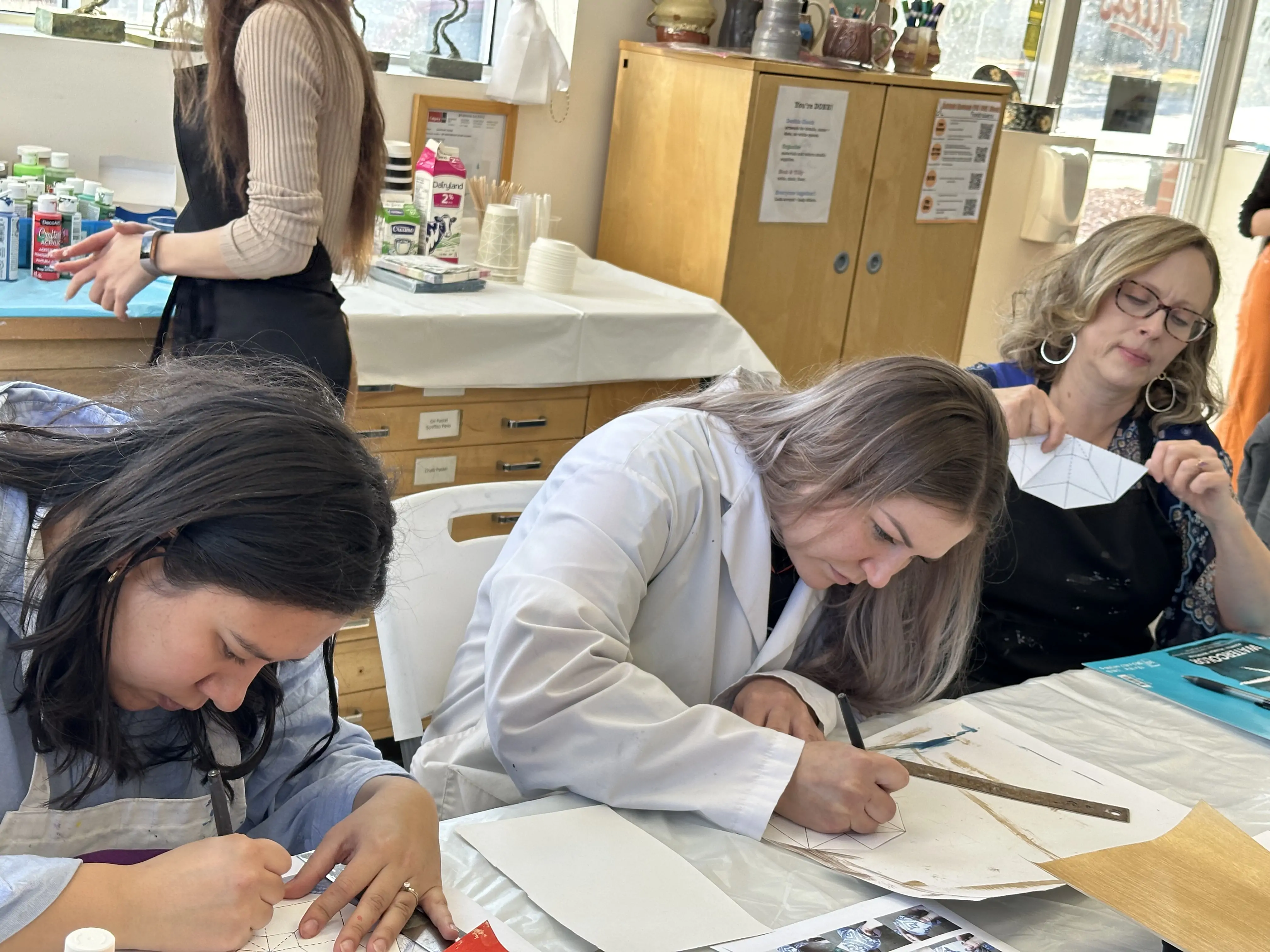 adults working on geometric drawing designs during an art workshop at Aliki’s Art House in Calgary